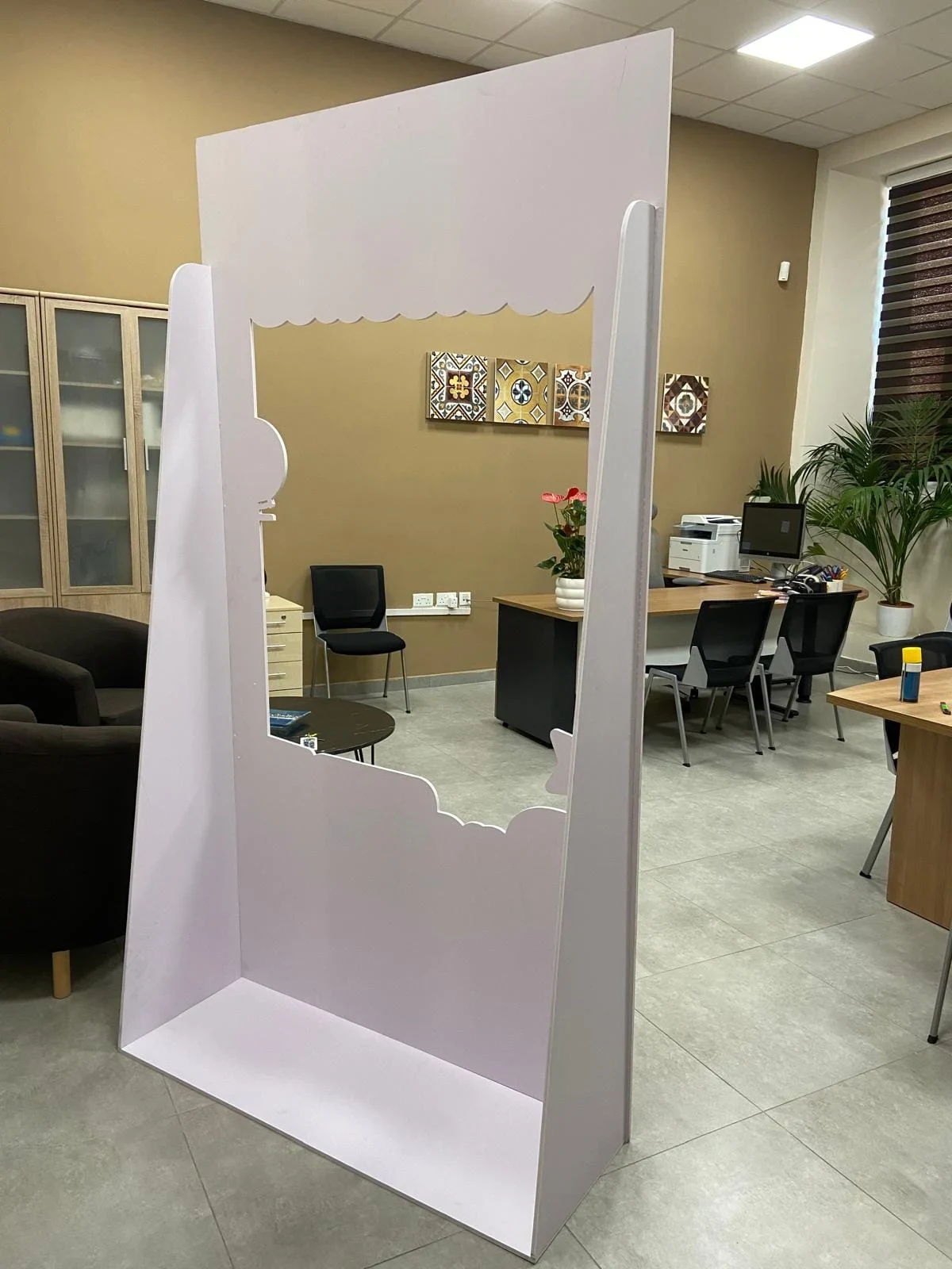 The same free-standing frame as a blank contour-cut board before its print was applied
