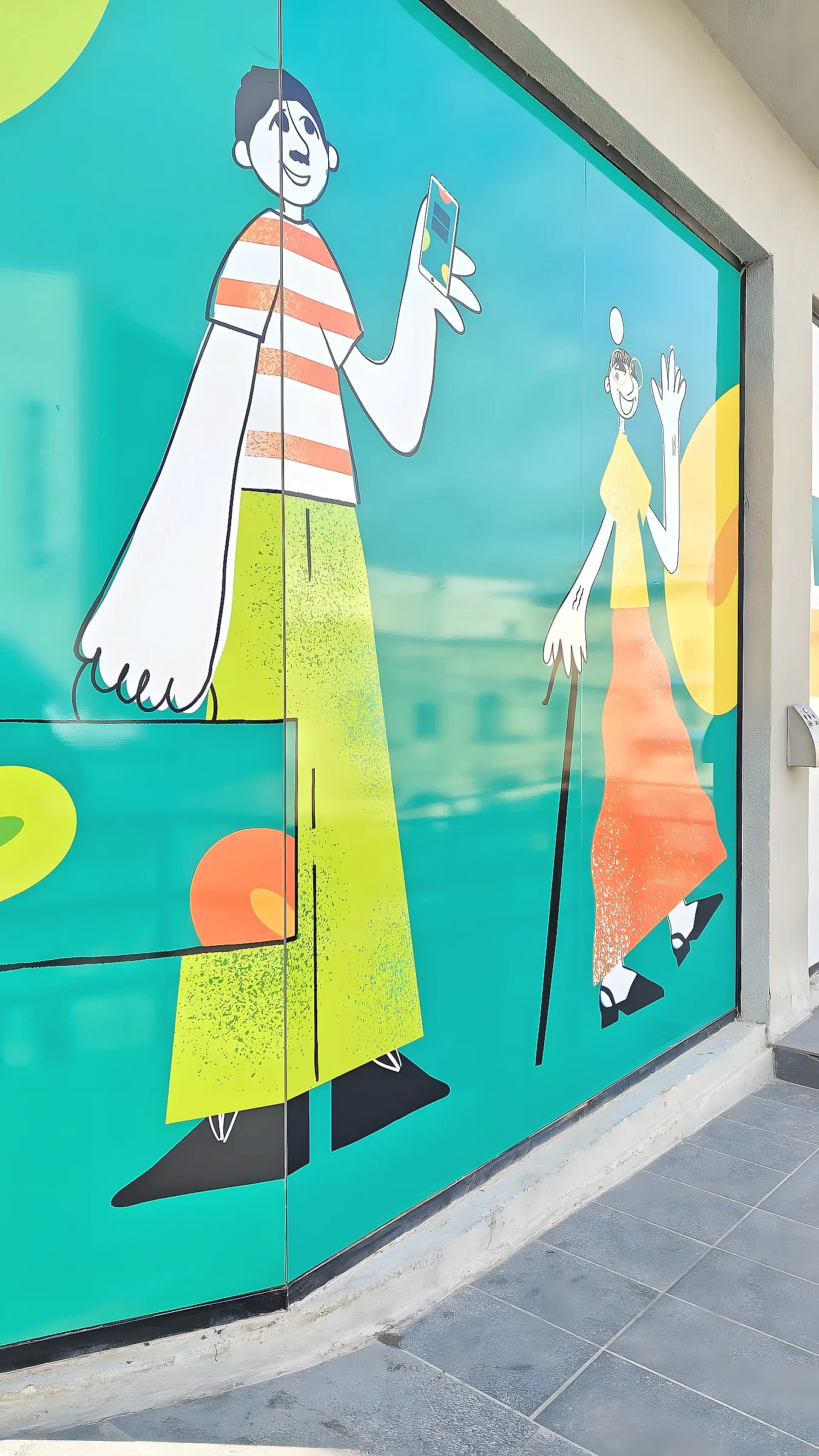 Teal window graphic of two illustrated figures covering the full height of a curved shopfront