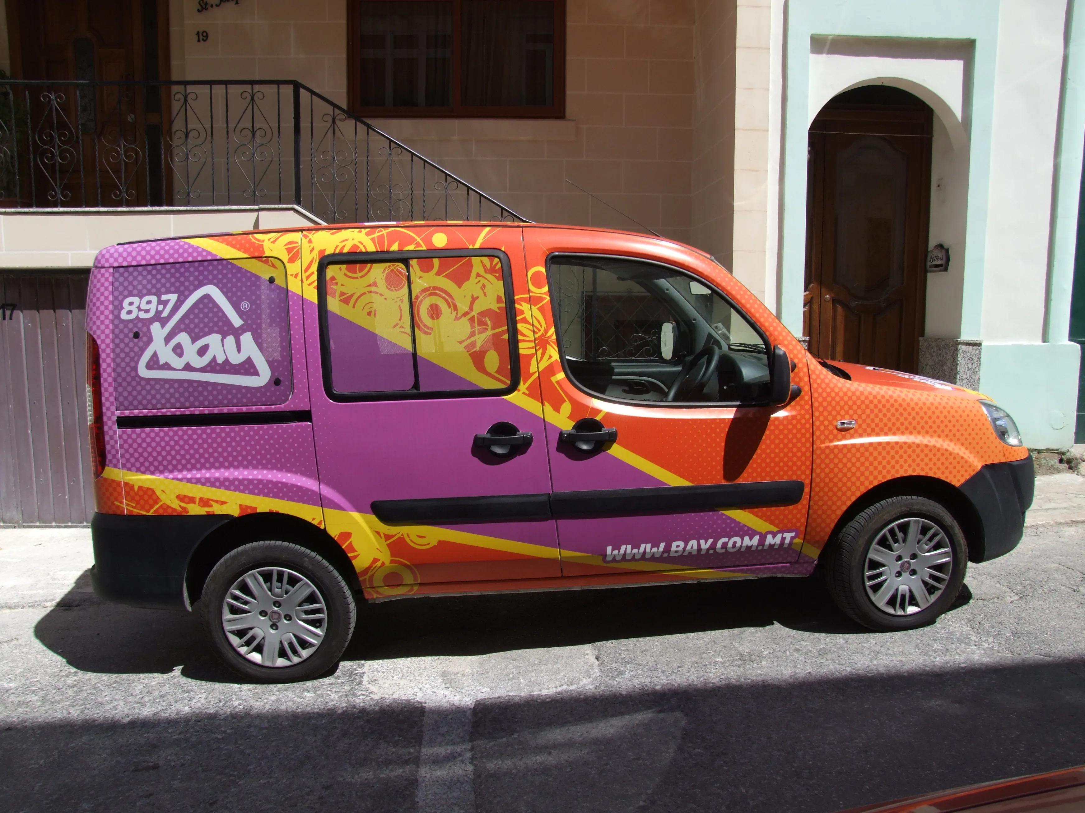 The same fleet scheme in a second colourway, purple through orange, with the diagonal flash and patterned ground carried over the bonnet and flank