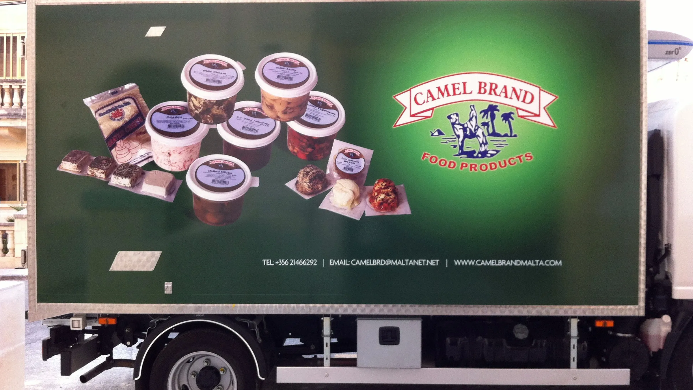 Side of a refrigerated delivery truck carrying a large printed product panel