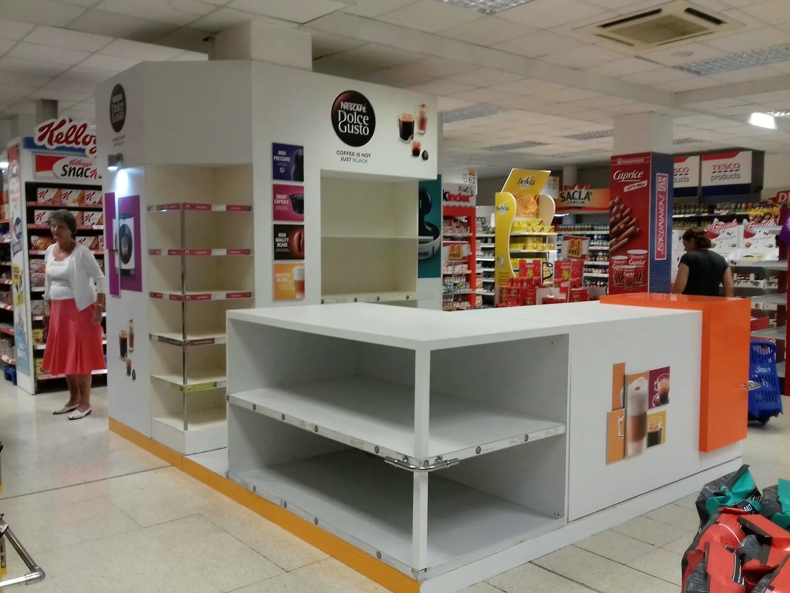 Modular retail counter and gondola shelving installed in a supermarket