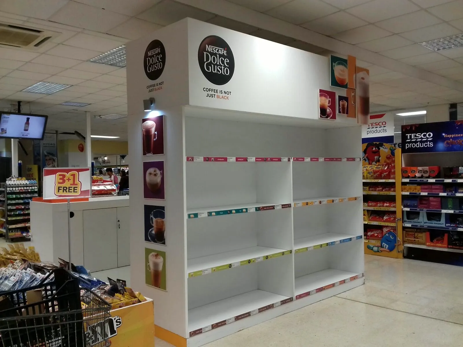 Tall retail shelving unit installed at the end of a supermarket aisle