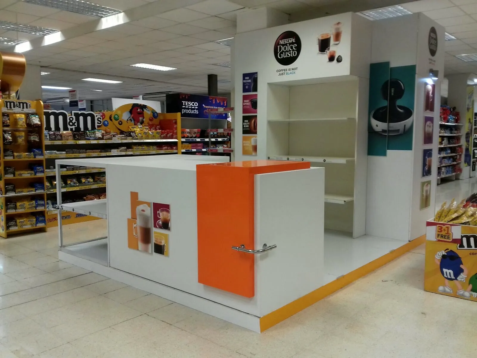 Installed retail counter and shelving system in a supermarket aisle