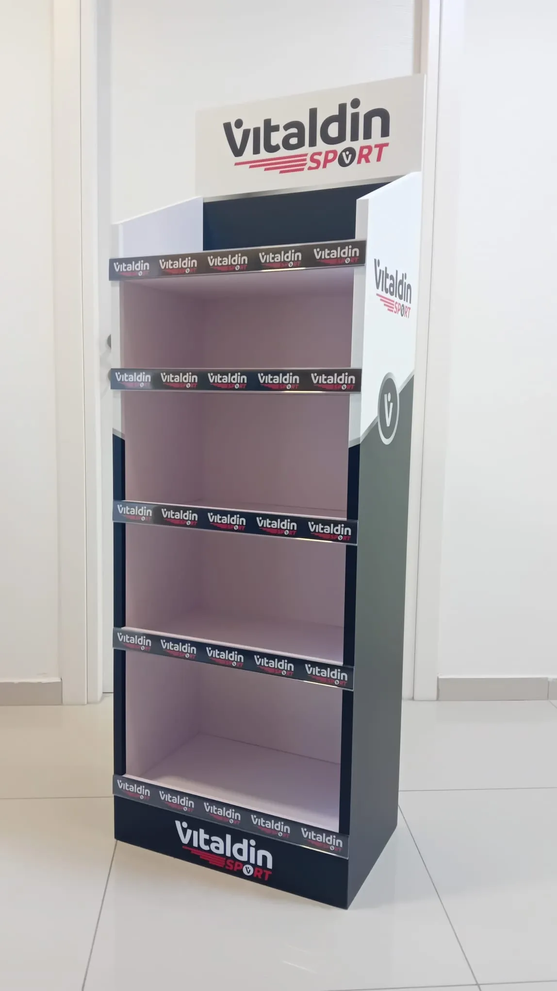 Black and white four-shelf retail display unit with a branded header and printed shelf strips