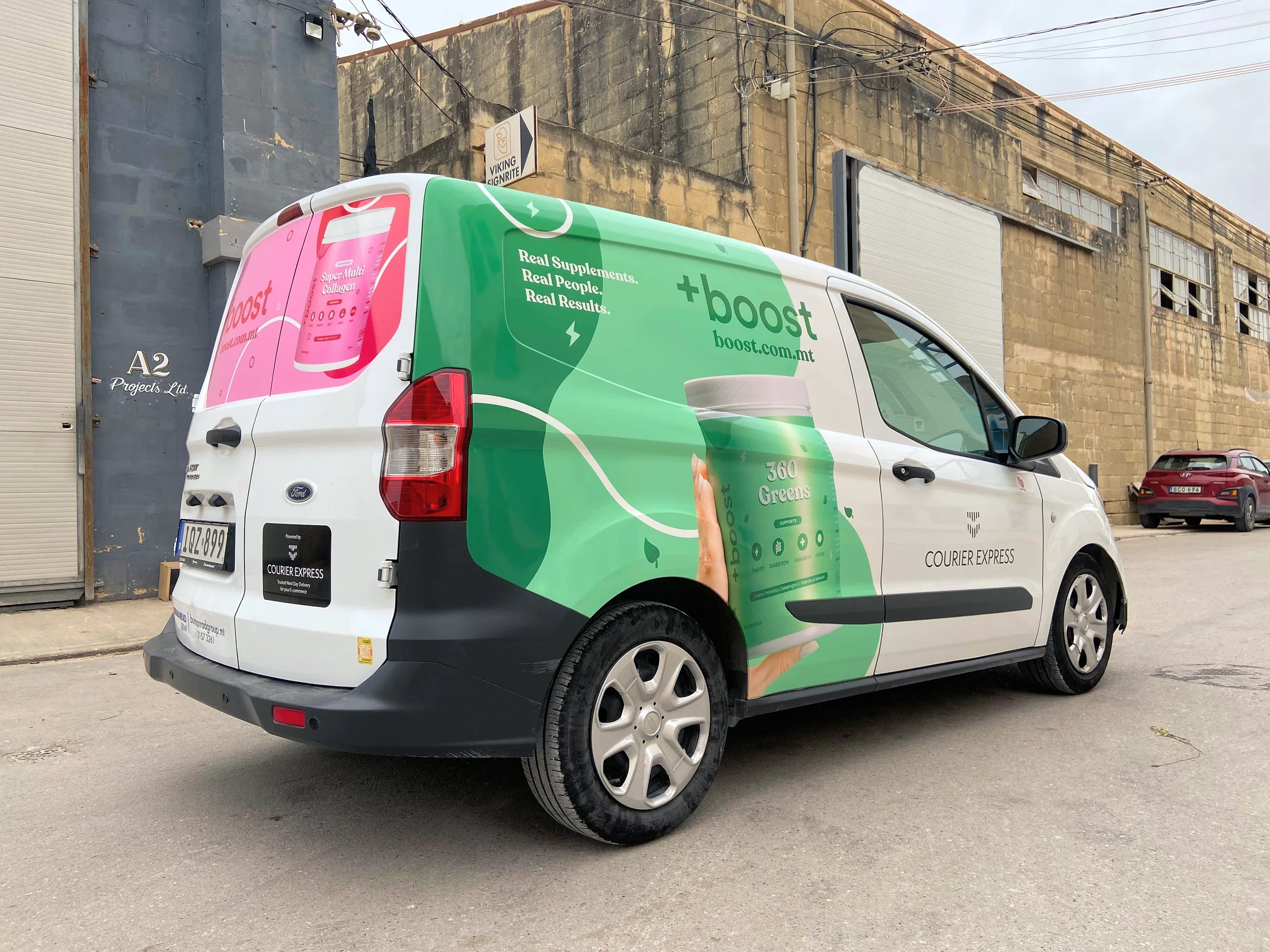 Green and white wrapped courier van with a supplement tub printed along its side panel
