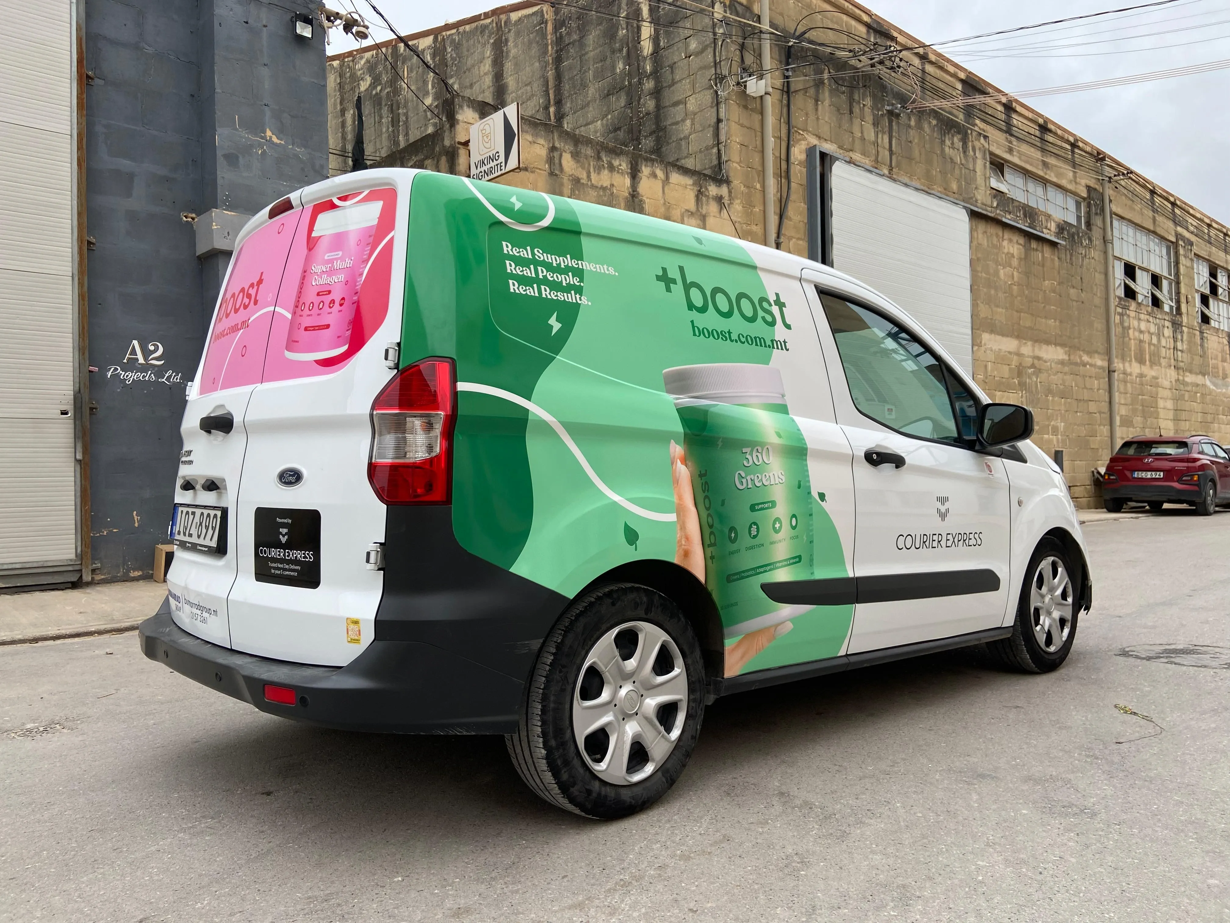 Green and white wrapped courier van with a supplement tub printed along its side panel