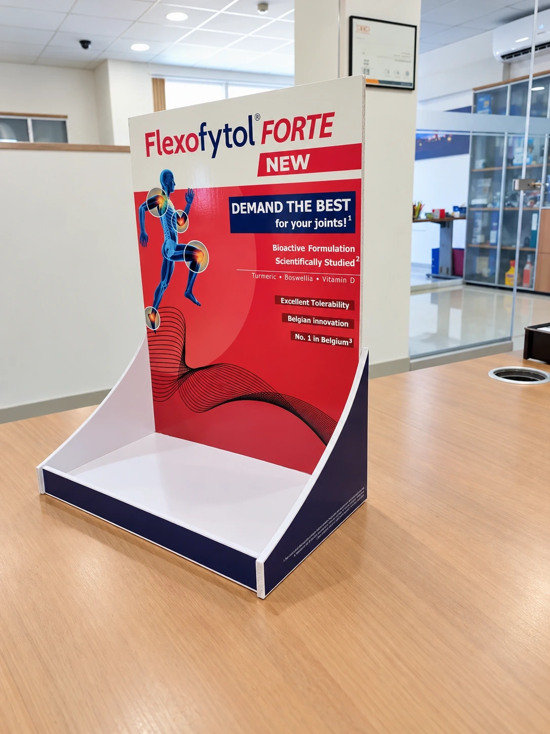 Printed counter display unit with a curved header standing on a wooden table