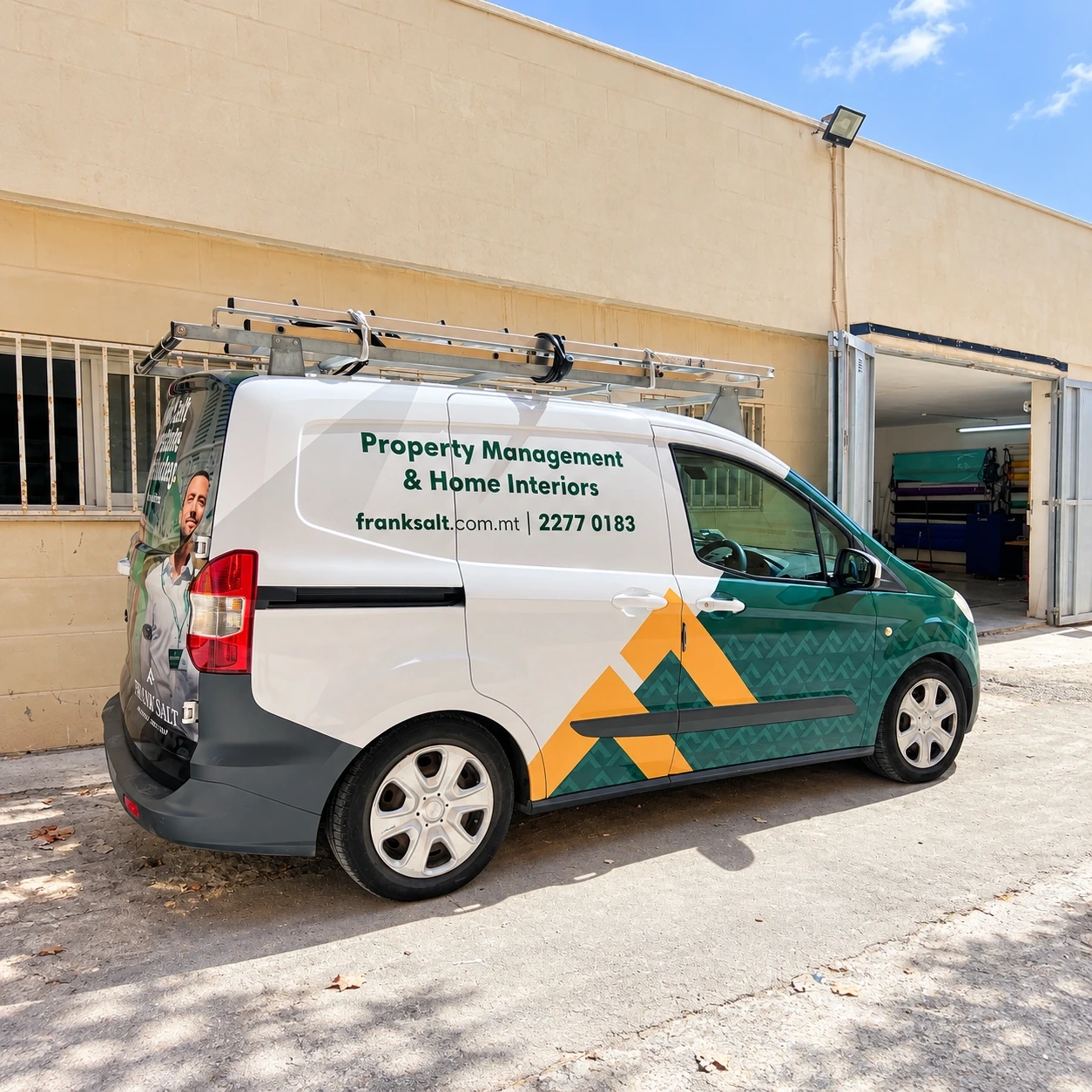 Small van in green and white livery with a geometric pattern and a roof rack