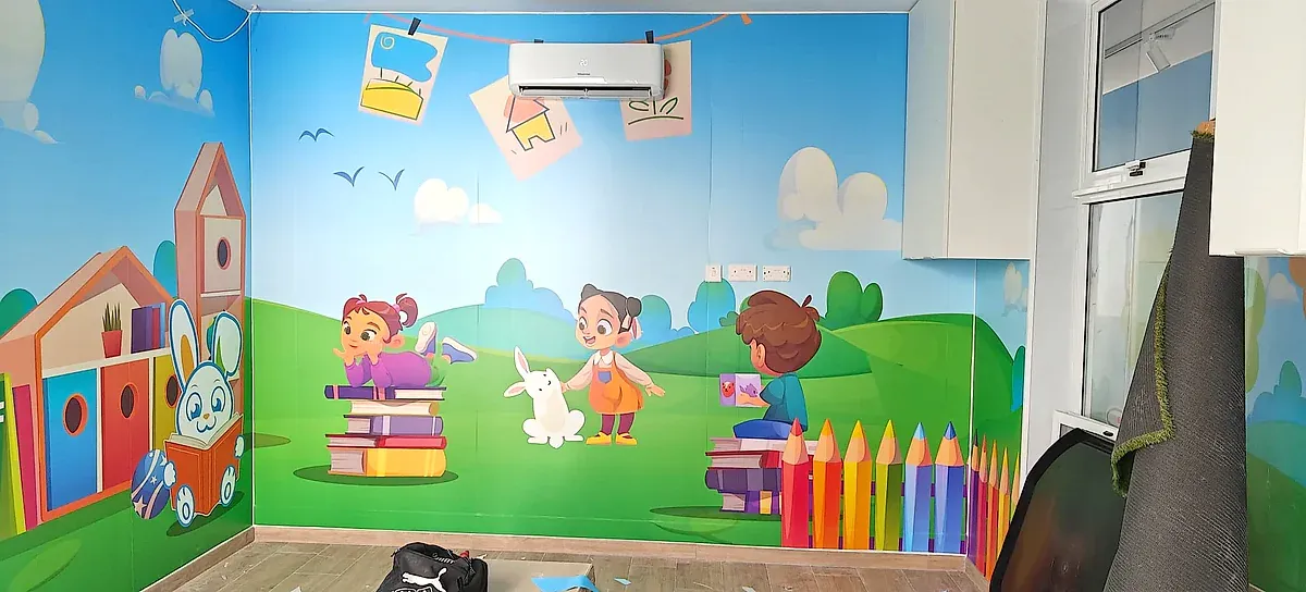 Children's playroom with printed wall murals of characters, books and oversized pencils