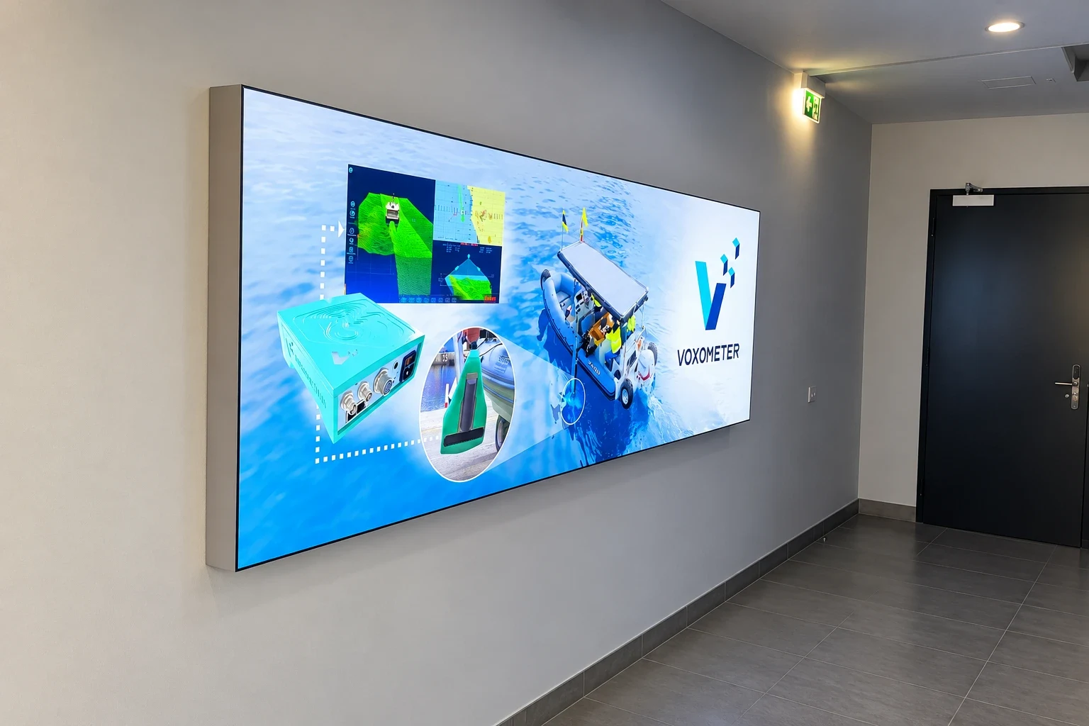 Wide backlit wall panel printed with marine survey equipment photography in a dark corridor