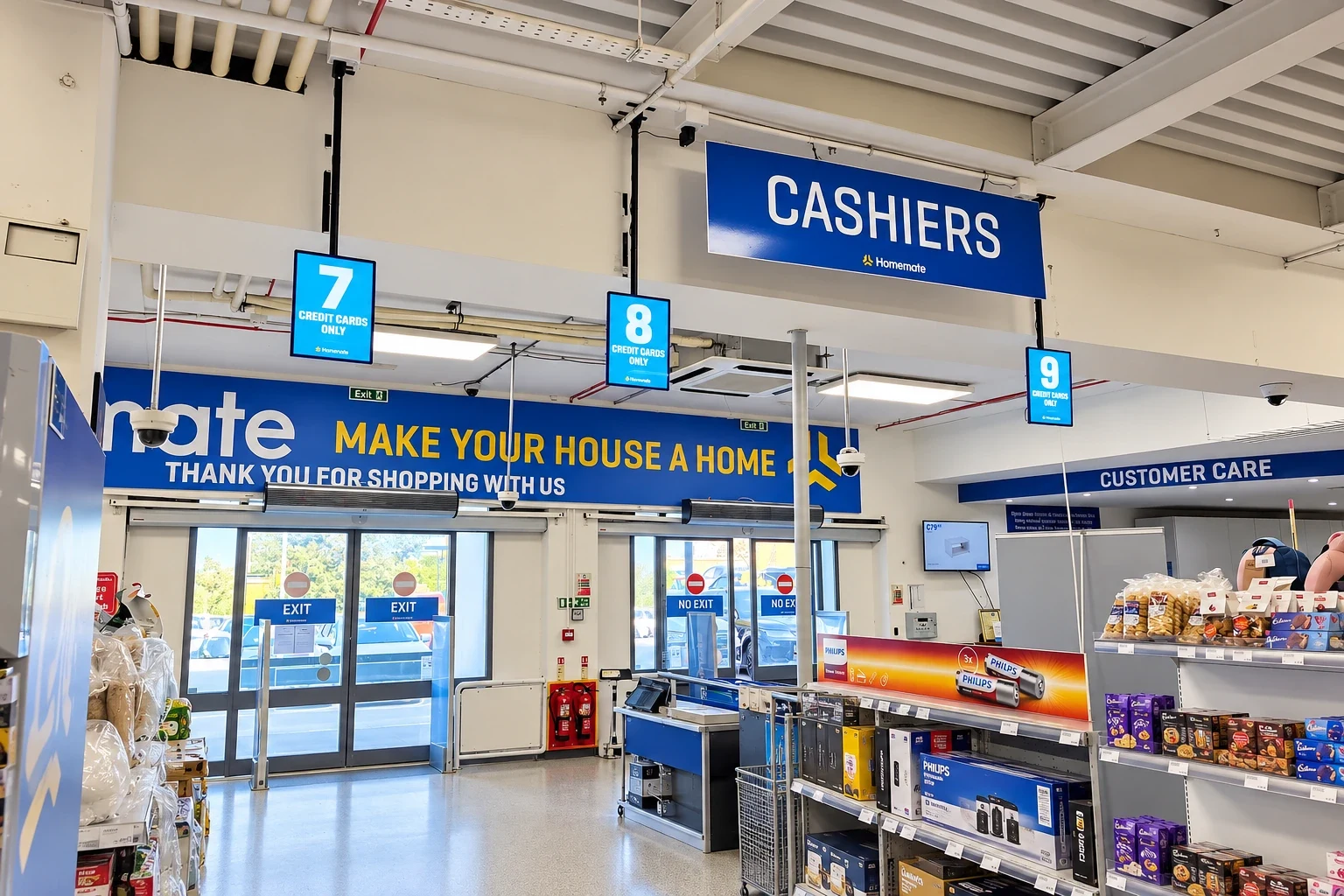 Blue overhead cashiers sign with numbered lane boxes above supermarket checkouts