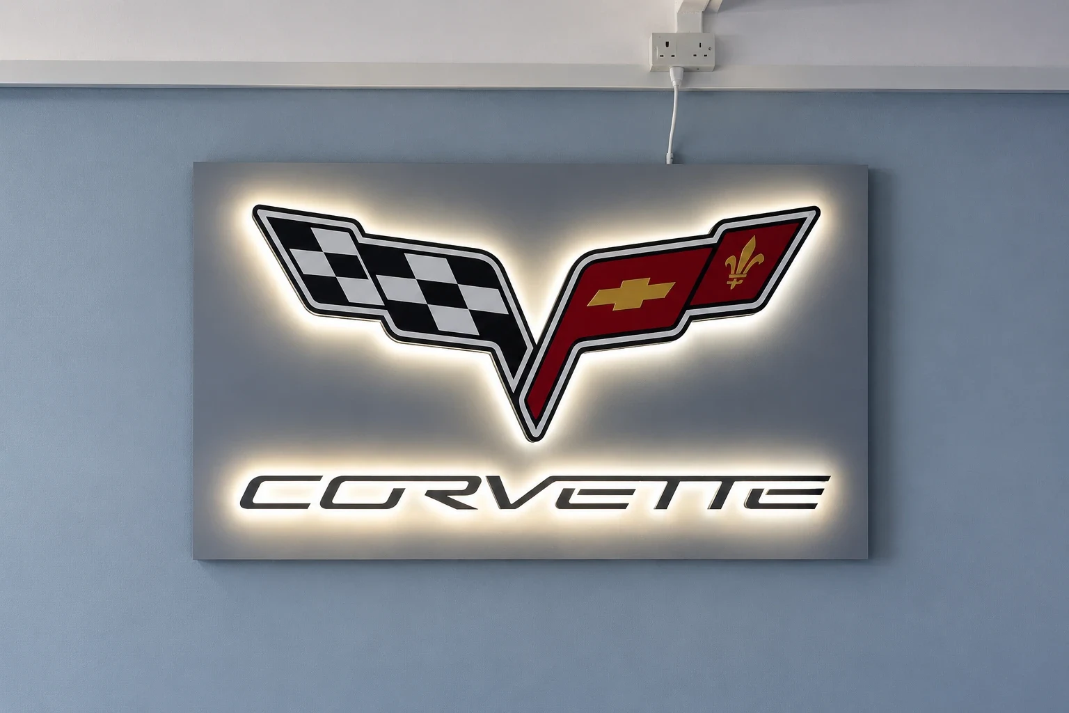 Halo-lit car emblem panel glowing on a plain grey interior wall above a tiled floor