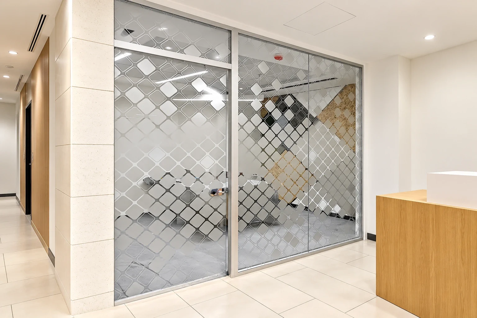 Full-height glass partition and sliding door covered in a frosted diamond lattice pattern