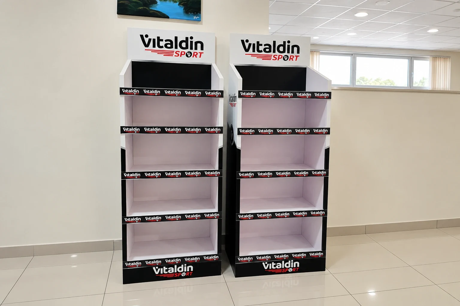 Two identical branded four-shelf display units standing side by side in a showroom